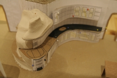 Model pece a kamen s navazující kuchyní.