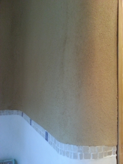 Mezi ručně hlazenými vodě odolnými omyvatelnými omítkami (marocký štuk "Tadelakt") a hliněnými omítkami je ručně skládaná mozaika z kouskú mramoru.